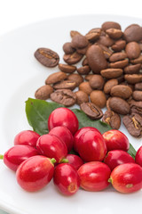 Red berries and roasted coffee beans on a white plate