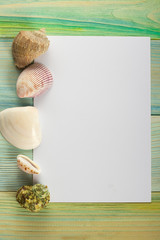 Summer sea vacation mockup background. Notebook blank page with Travel items on blue green wooden table. Sea shells, pebbles, top view.