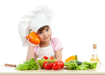 happy child girl preparing vegetarian dish
