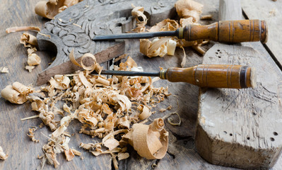 Woodworking tools with wooden background and shavings