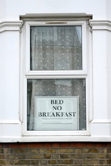 Window with sign "Bed no breakfast"