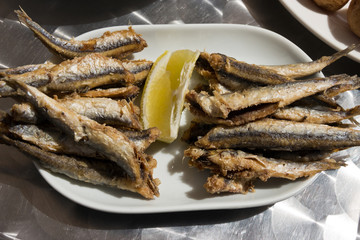 Fried anchovies with lemon served as tapas. Spanish boquerones fritos - Shot taken in Canary Island


