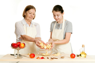the grandmother and the granddaughter fill ingredients in a bowl