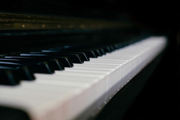 Close-up monochrome shot of piano keyboard, small depth of field, black and white.