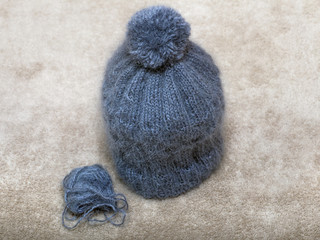 knitted baby hat with bells of blue mohair