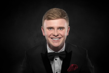 Fototapeta premium Young handsome man in black suit.