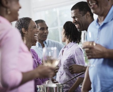 A group of African Americans of similar age, the baby boomer generation, having a party, Men and women, 