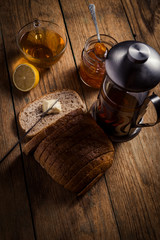 Homemade citrus orange jam on toast over wooden table