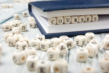 Courses word written on wood block. Wooden ABC
