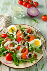 Smoked salmon salad with arugula, tomatoes, eggs and red onion