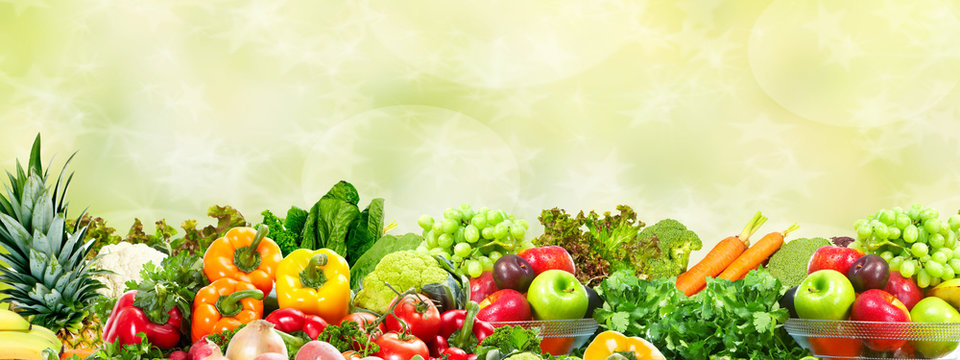 Vegetables and fruits over green background.