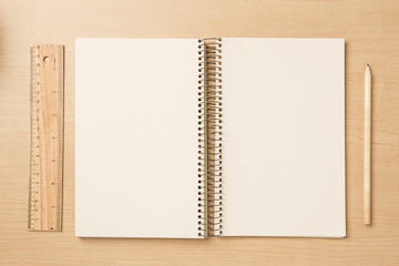 Notebook with pencil and ruler on a table,Earth tone,  flat top view