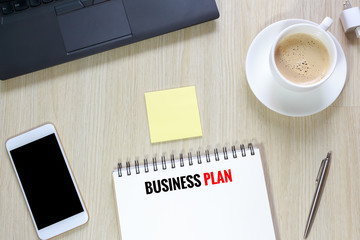 Top view of Business plan on desk  with computer, smartphone,sta