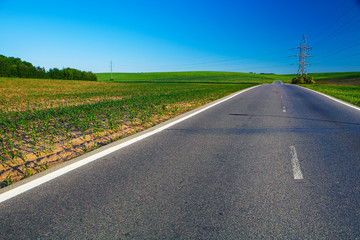 Fototapeta na wymiar speed highway through the field. asphalt-paved road