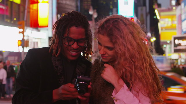 Couple taking photos together in Times Square