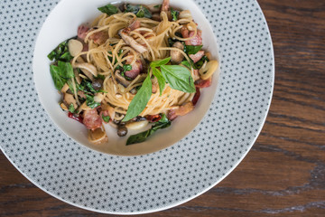 Spicy Spaghetti with dried chilli and bacon on wood table. Top view
