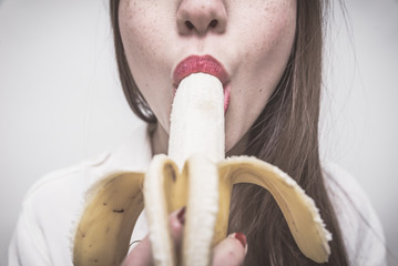  Tasty banana. woman eating a banana. close up view