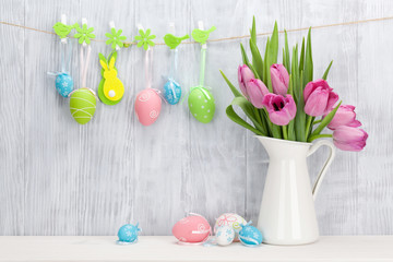 Easter eggs and pink tulips bouquet