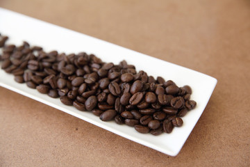 Coffee beans isolated in wood background