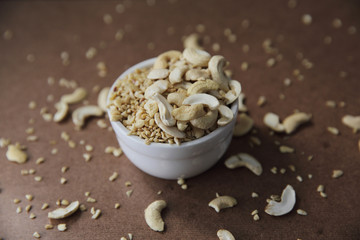 crushed peanuts on wood background in mystic light