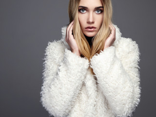young woman in winter fashion wearing a fur.beautiful blond hair model girl