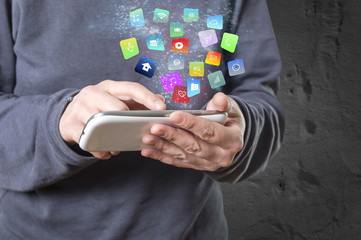 Woman holding a smartphone with modern colorful floating apps and icons.
