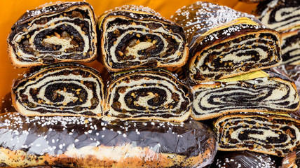 Sweet roll with poppy seeds, raisins and nuts.