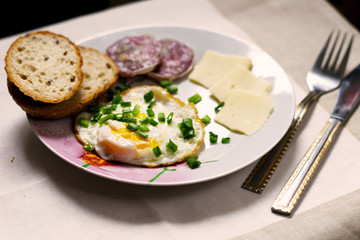 Fototapeta na wymiar light breakfast on the table with egg, bread, cheese and sausage