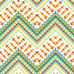 Seamless hand drawn chevron pattern with aztec ethnic and tribal ornament. Vector bright colors boho fashion illustration.