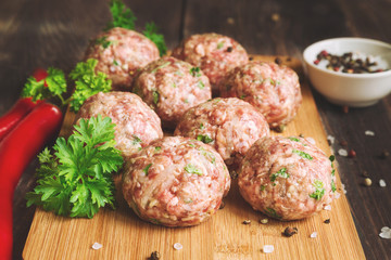 Raw meatballs with parsley and chili peppers