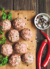 Raw meatballs with parsley and chili peppers