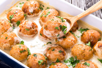 meatballs smothered in a creamy gravy sauce, close-up