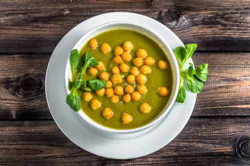Italian broccoli soup or cream soup on wooden table.