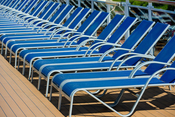 A lot of blue sunbed into a cruise ship on summer day
