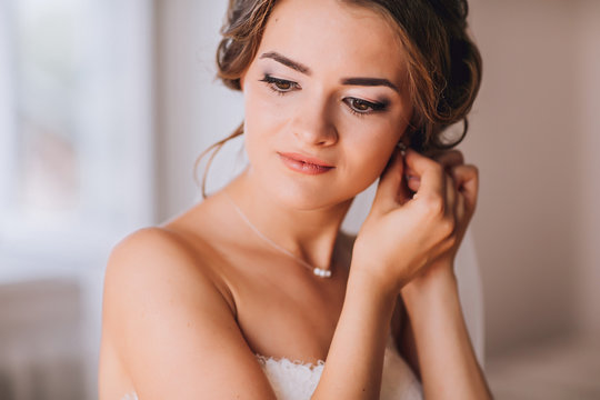 beautiful brunette stylish bride getting ready in the morning in the room