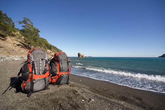 Backpacks on the sea coast in the summer on a sunny day.