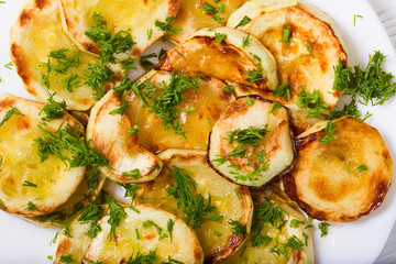 Appetizing vegetable marrows, fried in oil and strewed with gree