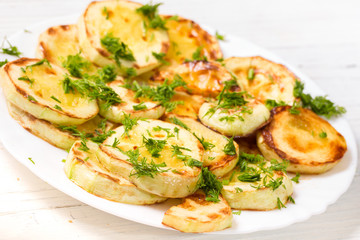 Appetizing vegetable marrows, fried in oil and strewed with gree