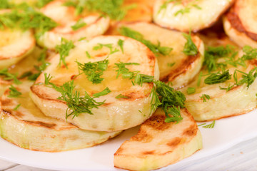 Appetizing vegetable marrows, fried in oil and strewed with gree