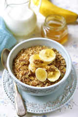 Granola with milk and banana slices.