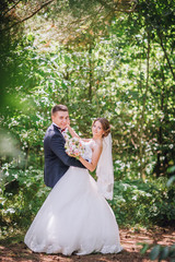 Married Couple in forest embracing and dancing