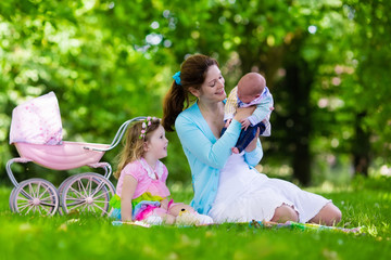 Mother and kids enjoying picnic outdoors