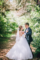 Married Couple in forest embracing and dancing