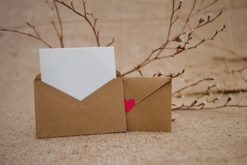 Romantic envelope with heart and love letter on fabric background. The best present for valentines day.