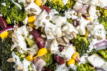 Broccoli salad with vegetables and feta cheese. © alicja neumiler