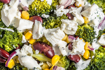 Broccoli salad with vegetables and feta cheese. © alicja neumiler