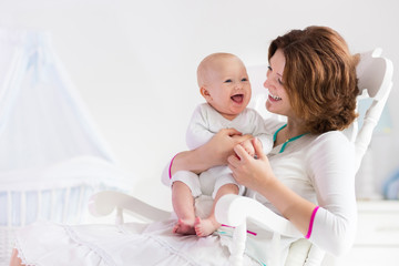 Mother and baby in white bedroom