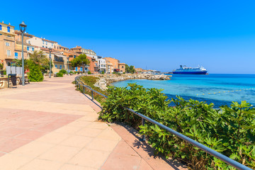 Promenade along sea in Ile Rousse coastal town, Corsica island, France