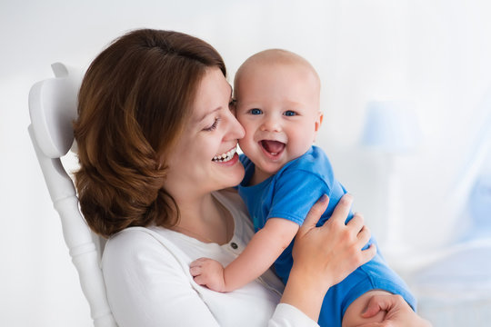 Happy young mother with baby boy at home - Powered by Adobe