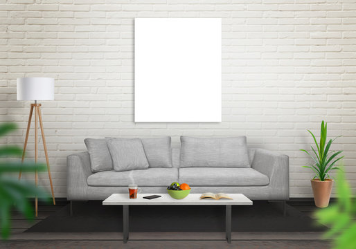 Isolated art canvas in living room for mockup. Brick white wall and black wooden floor. Sofa, table, lamp and plant in room.